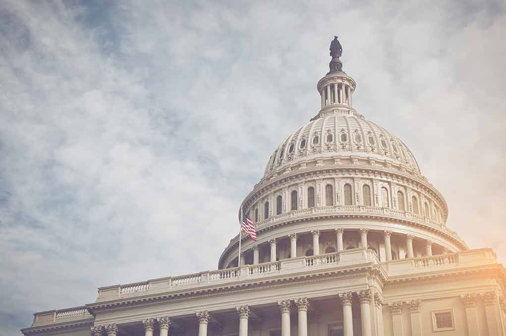 365373944 featured image Capitol dome with American flag, under cloudy sky.