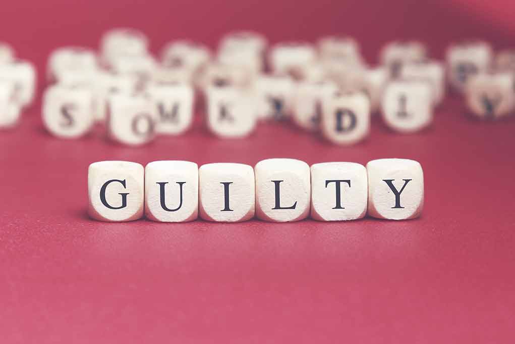 441191092 featured image Dice spelling guilty on a red surface