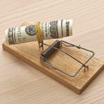 Leadership Turmoil and Financial Controversy Unsettle Prominent Healthcare Union Mousetrap baited with rolled dollar bills on table