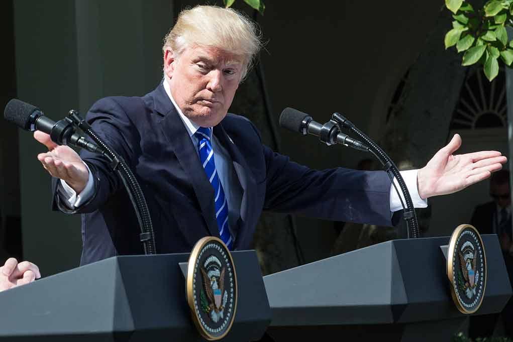 1456093781 featured image Man gesturing at two podiums outdoors.