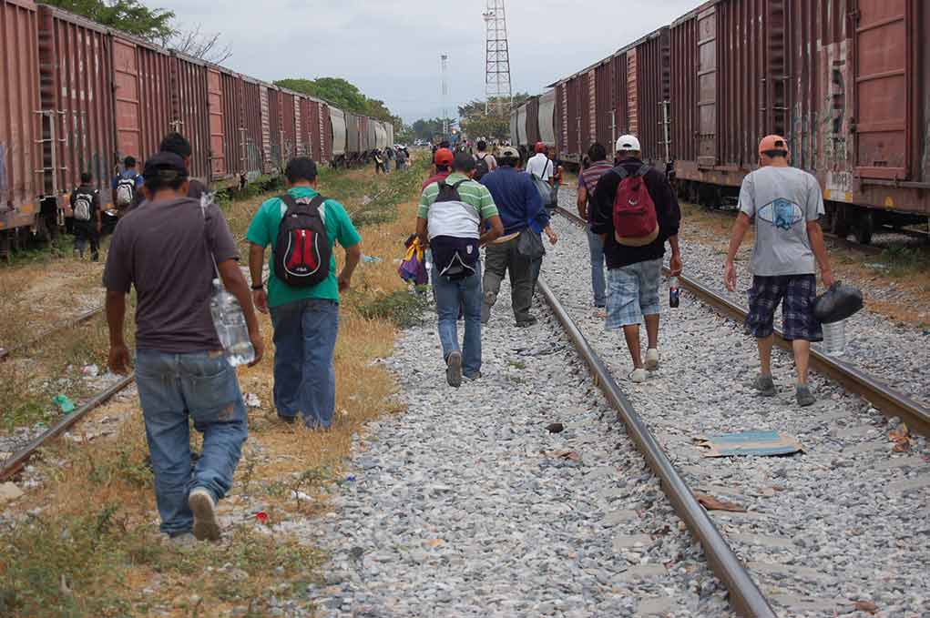 1119750086 featured image People walking along train tracks carrying backpacks
