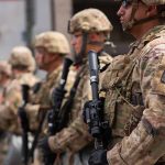 Tension Escalates: Global Leaders Disagree on Gaza Blockade Strategy Soldiers in camouflage standing in a line with rifles