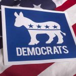 SHOCKING MOVE: Tuberville Eyes New Position Democrats logo with donkey on American flag background