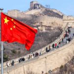 Western Pacific on EDGE – One Mistake Could Ignite War Chinese flag by the Great Wall of China
