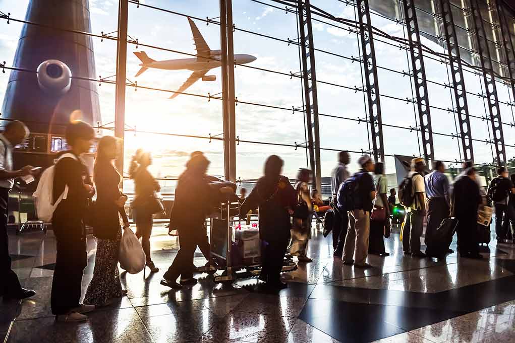 People in line at busy airport terminal