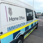 ICE Raid Has SHOCKING Result— Locals Rush In White immigration enforcement van parked by roadside