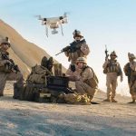 US Forces TARGETED in Iraq — Retaliation Coming? Soldiers operating a drone in a desert environment