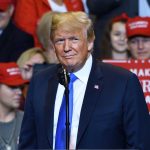 Nation’s Borders WEAKENED—Is Agriculture to Blame? Person at a rally with Make America Great Again signs