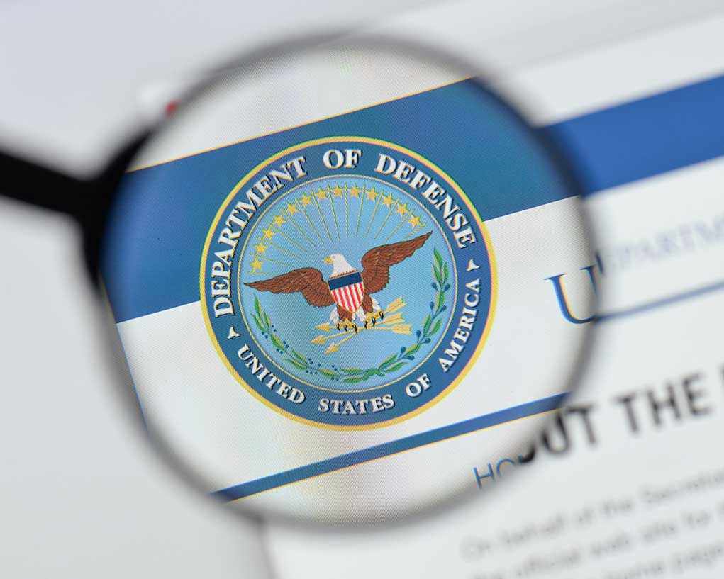 1170026380 Magnifying glass over Department of Defense logo