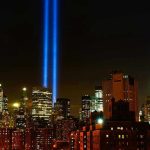 New York City skyline at night with memorial lights