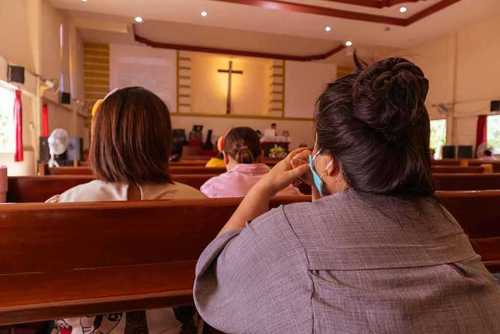 1773600770 People sitting in church pews during service