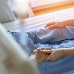 Plague Strikes —Officials COMPLETELY Caught Off Guard Hospital patient holding visitor's hand reassuringly.