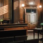 Empty courtroom with wooden interior and green lamps