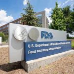 At a Glance FDA building sign with blue sky background