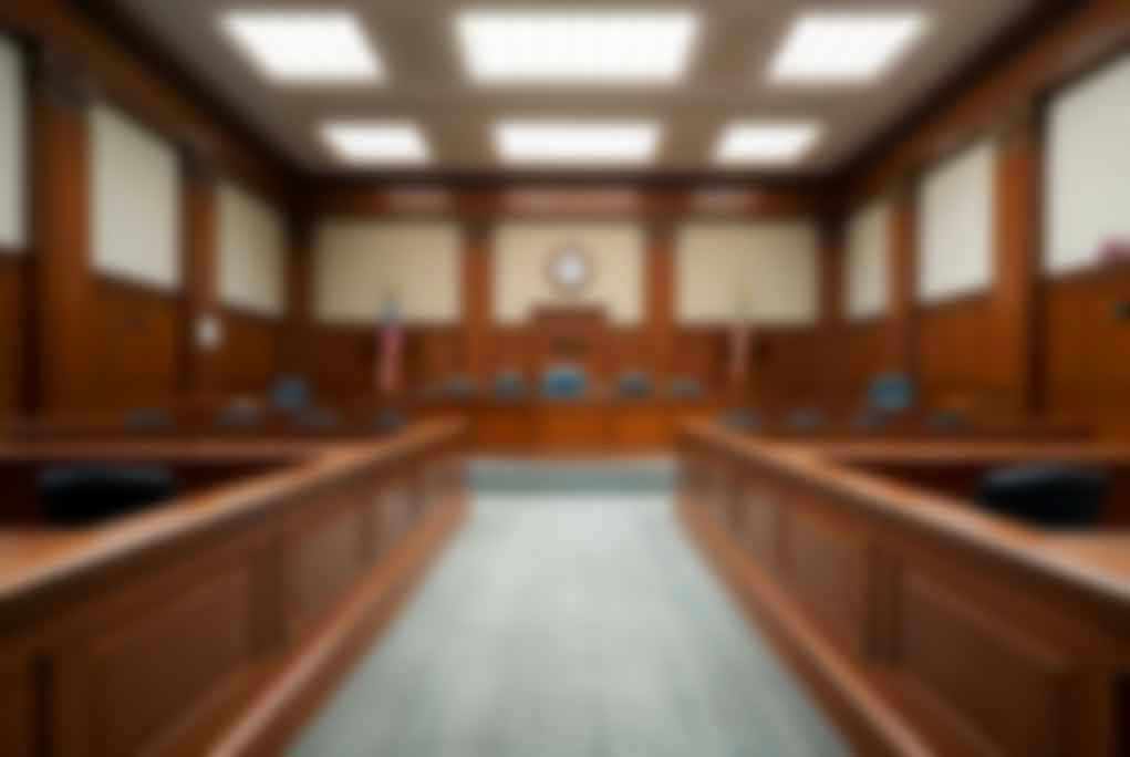 2324977165 Empty courthouse courtroom with wooden benches and chairs