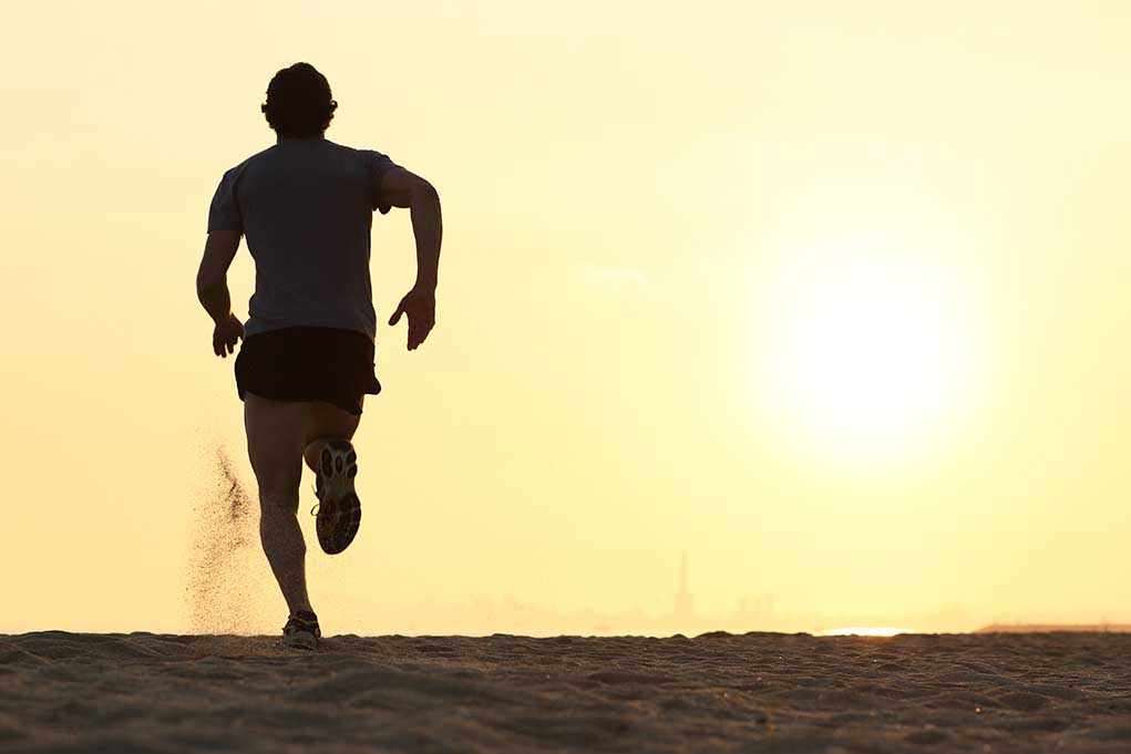 shutterstock_179825510.jpg Silhouette of a man running on the beach during sunset