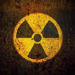 Nuclear Giant Blindsided By Jellyfish Wall Yellow radiation warning symbol on rusty metal surface