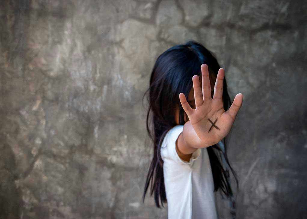 Person with an X on their palm