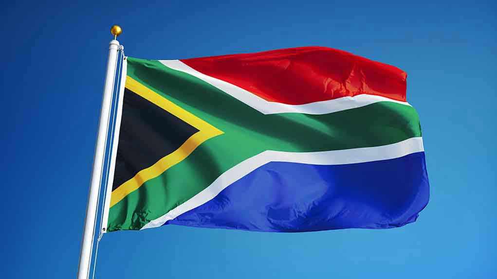 478550506 South African flag waving against blue sky