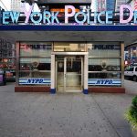 Arsonist’s Chaotic Rampage Stuns NYPD NYPD precinct building with signs on a city street