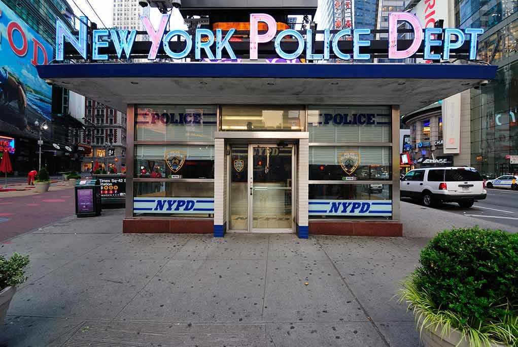 56798539 NYPD precinct building with signs on a city street