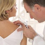 Toxic Underwear Scare Doctor examining a patients skin with a magnifying glass