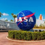 NASA STUNS – Signs of Life Discovered! NASA logo sculpture with spaceship and palm trees.