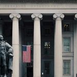 “Drop Dead” – Treasury’s Blunt Warning To Socialist! US Treasury Department building with statue and flag.