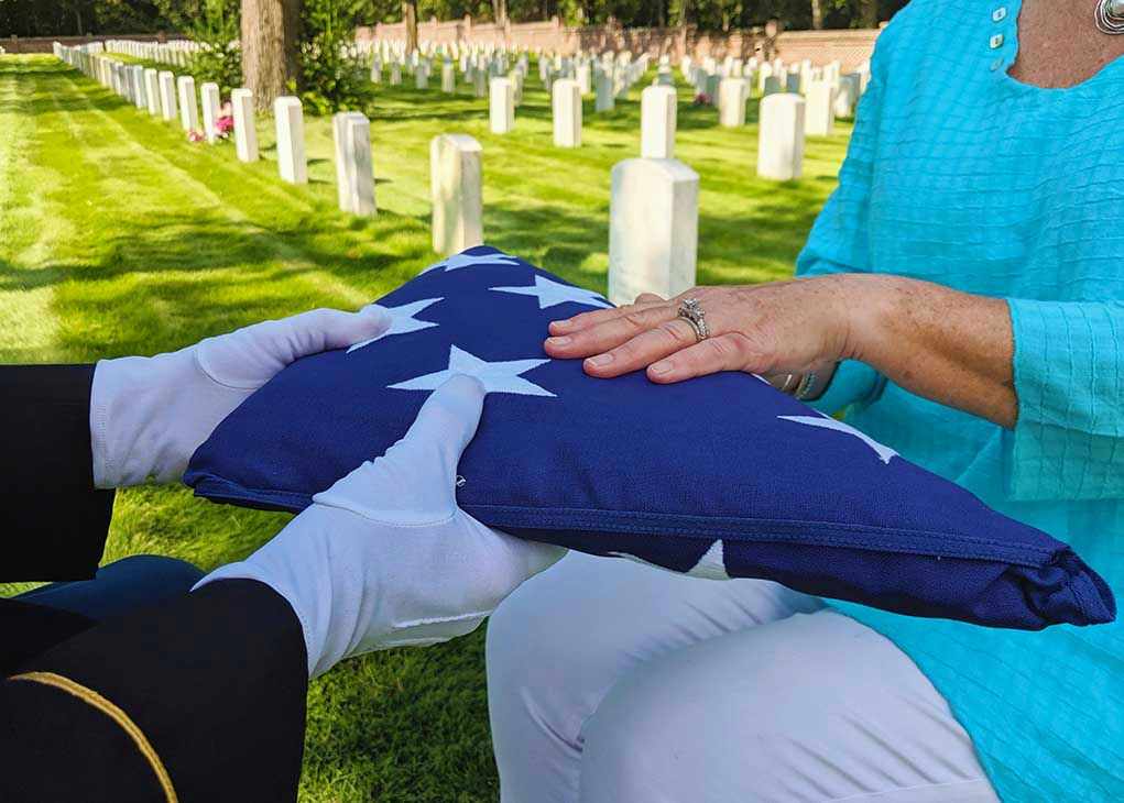 Flag folded and handed over at gravesite ceremony.