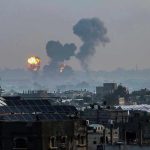 Gaza Health Crisis EXPLODES — Hospitals Overwhelmed! Flames and smoke billowing over a cityscape.