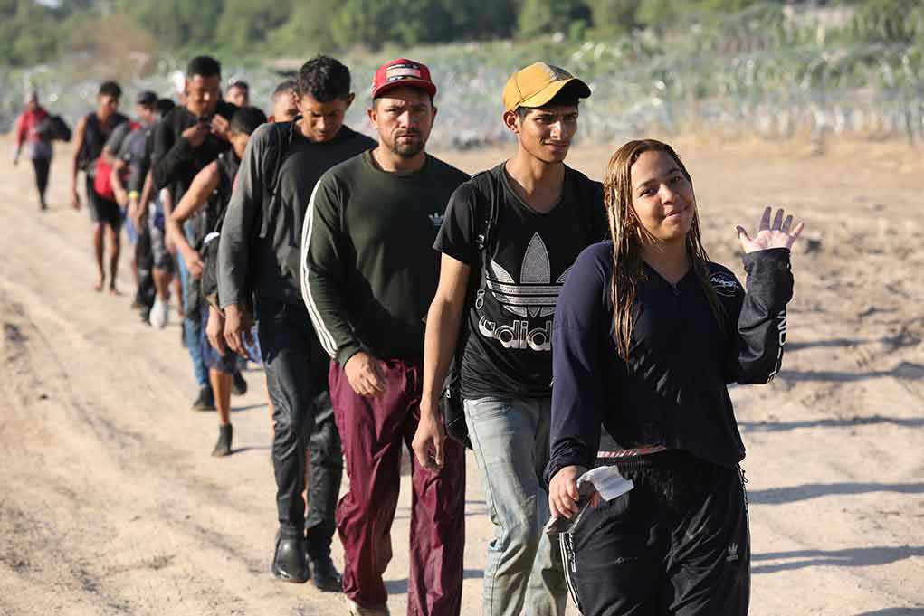 Group of people walking in a line outdoors.