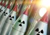Line of nuclear missiles with radiation hazard signs.