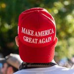 TRUMP 2028 Hat Stuns Oval Office – DEMS FUMING! Person wearing a red Make America Great Again hat.