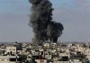 Large explosion over a crowded urban area.