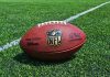 NFL Pro ARRESTED – Dies in Custody! NFL football on a green field.