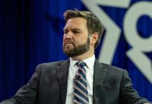 VANCE BLASTS Massie — GOP Loyalty Questioned Man in a suit with a thoughtful expression.