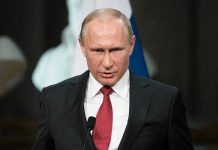 Putin Reveals NEW Nuke – World Panic! Person speaking into a microphone, official setting.