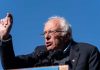 Sanders SLAMS Colleagues Campaign—Party Divided! A speaker passionately addressing a crowd at an outdoor rally