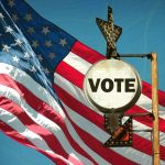 Cuomo Receives MASSIVE Endorsement – Campaign Boost! A vintage Vote sign in front of an American flag