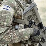 Israel BOMBS Refugee Camp – Mosque Attacked! Soldier in camouflage gear with Israeli flag patch.