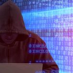 Person in hoodie using laptop surrounded by digital code