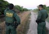 170-mile Police Chase Ends With Border Crossing Two U.S. Border Patrol officers observing a dirt path.
