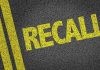 Yellow RECALL text on asphalt background.