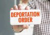 Loyal Trump Worker DEPORTED — ICE Scrambles! Hand holding sign with Deportation Order text.