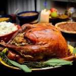Hidden Truth Behind Dropping Thanksgiving Prices—Not What You Think! A beautifully roasted turkey on a festive table surrounded by side dishes and decorations