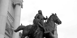 Bronze equestrian statue of a historical figure with a woman beside him