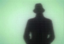 Mystery Deepens: Anti-AI Leader DISAPPEARS Silhouette behind frosted, textured glass in green light.