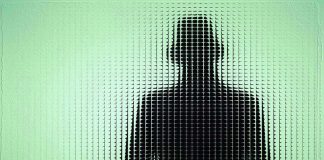 Silhouette behind frosted, textured glass in green light.