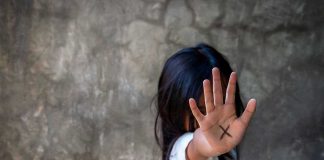 Person with an X on their palm.