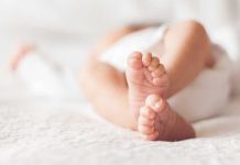 Stepfather’s HORRIFYING Secret: 11-Year-Old Gives Birth Close-up of baby feet lying on blanket.